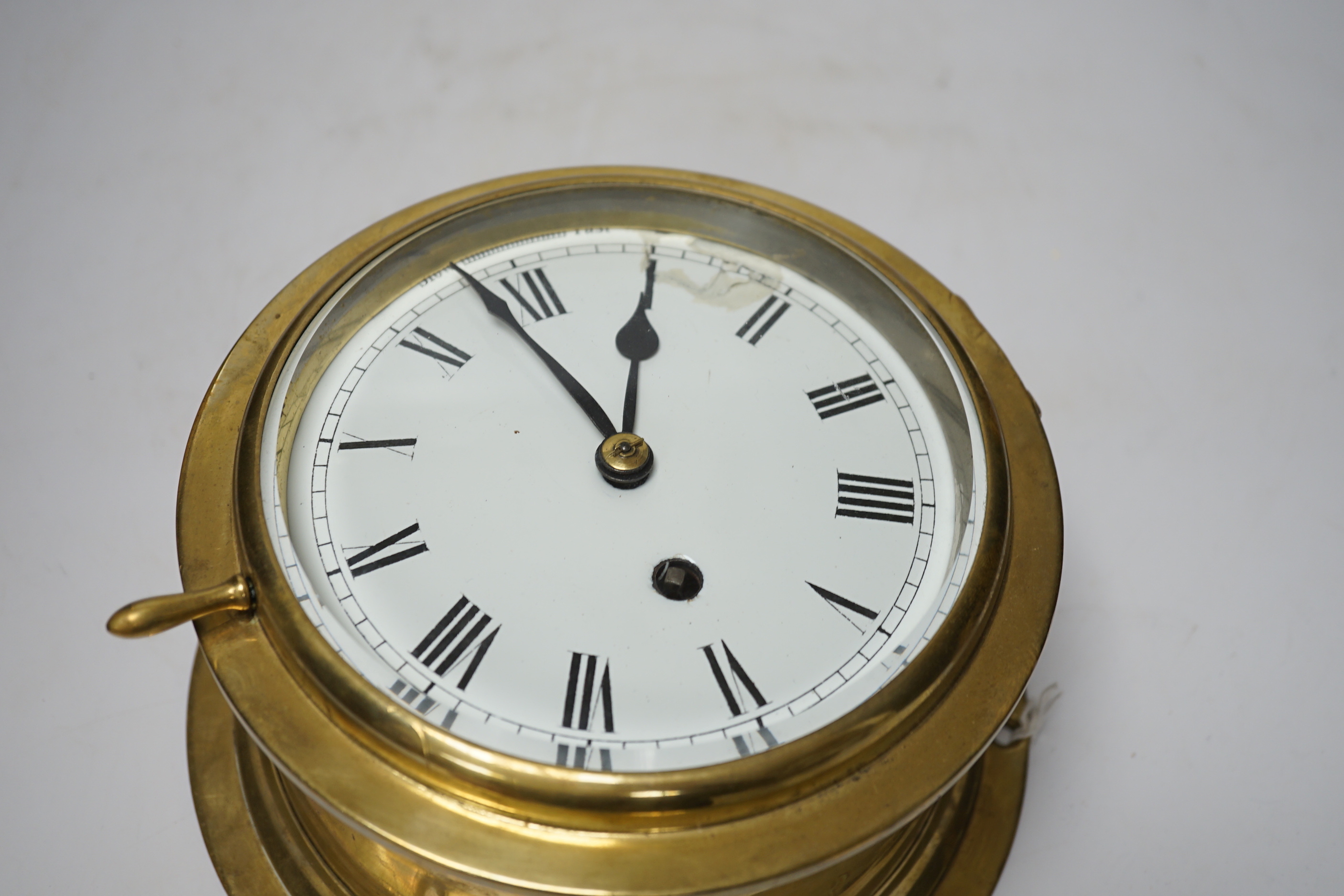 A brass ship’s bulkhead timepiece, 21cm diameter